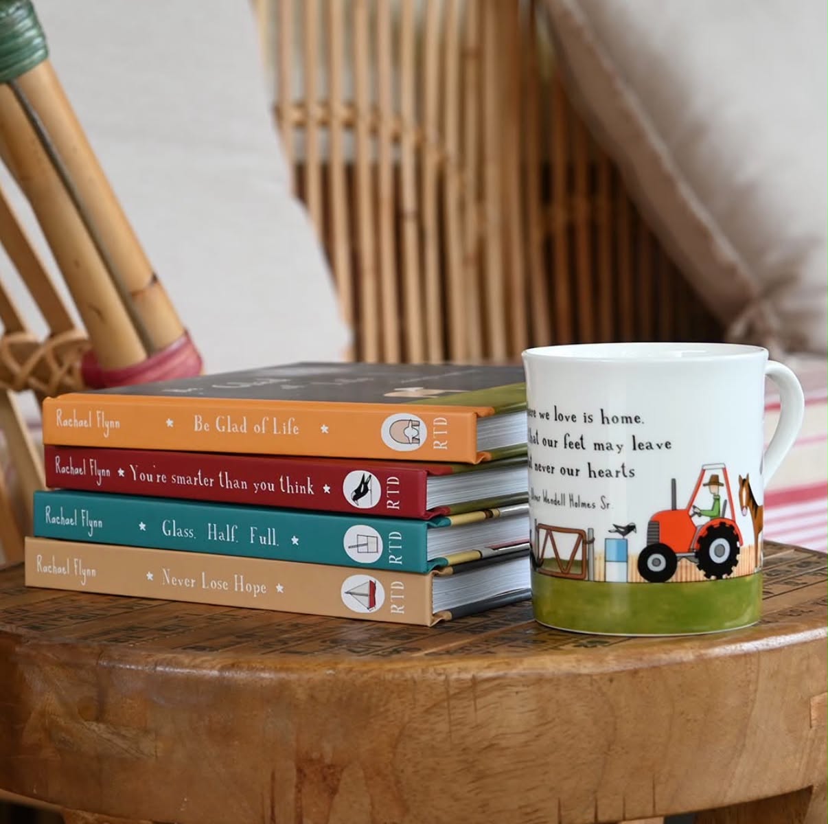 Stack of Red Tractor Designs books beside a bone china tractor mug